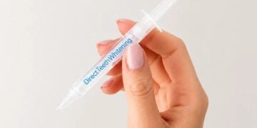 Direct Teeth Whitening Premium gel syringe held in hand