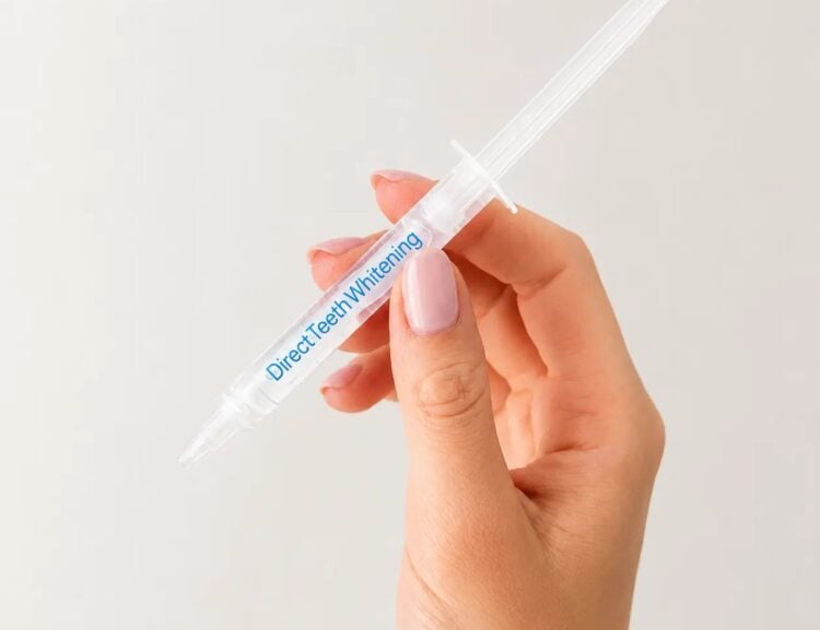 Direct Teeth Whitening Premium gel syringe held in hand