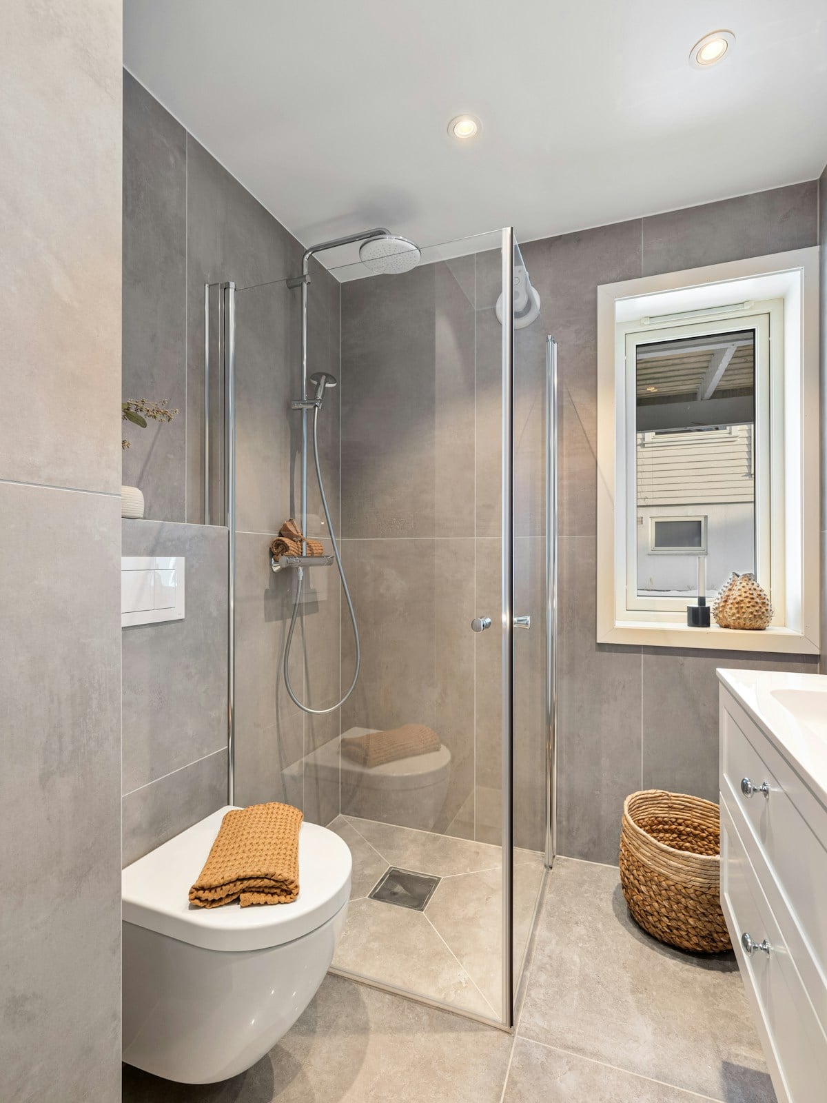 Bright bathroom vanity area with a wall mirror