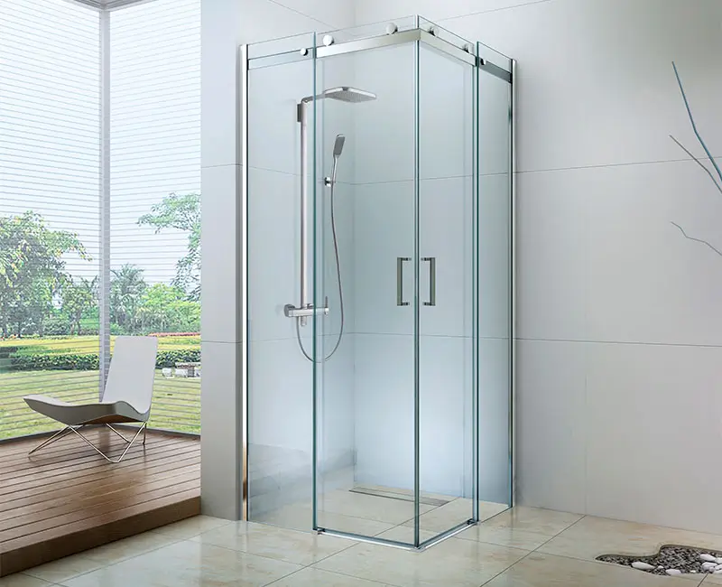 Glass shower cabin with chrome hardware in a bright bathroom