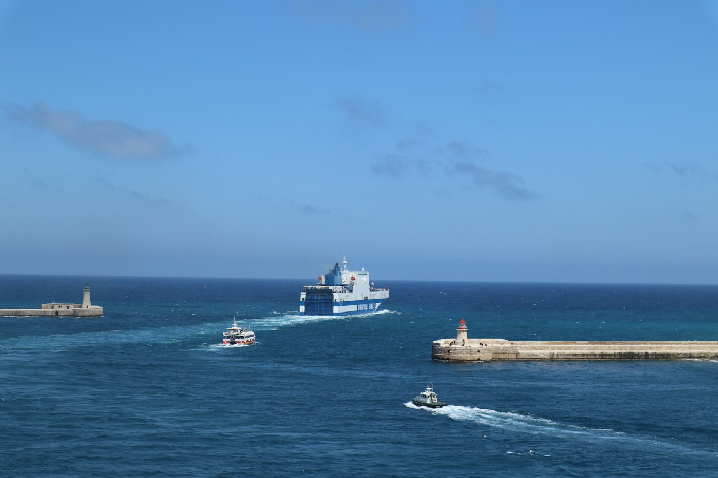 Ferry passing through a stone harbour entrance