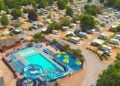 Aerial view of a holiday park with swimming pools and caravans