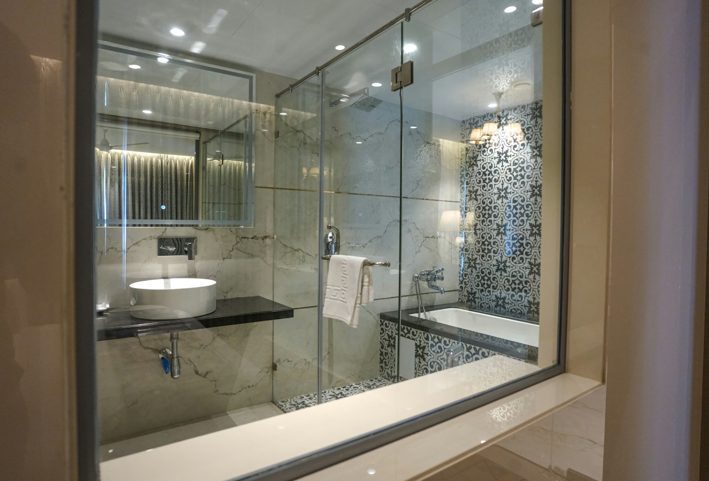 Marble bathroom with frameless glass shower and bathtub