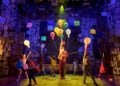 Young performers appear together in a scene from Matilda The Musical