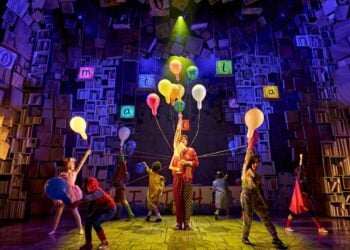 Young performers appear together in a scene from Matilda The Musical
