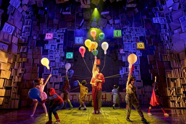 Young performers appear together in a scene from Matilda The Musical