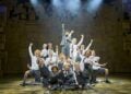 Matilda musical cast performing together on stage