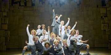 Matilda musical cast performing together on stage