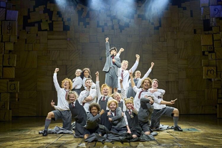 Matilda musical cast performing together on stage