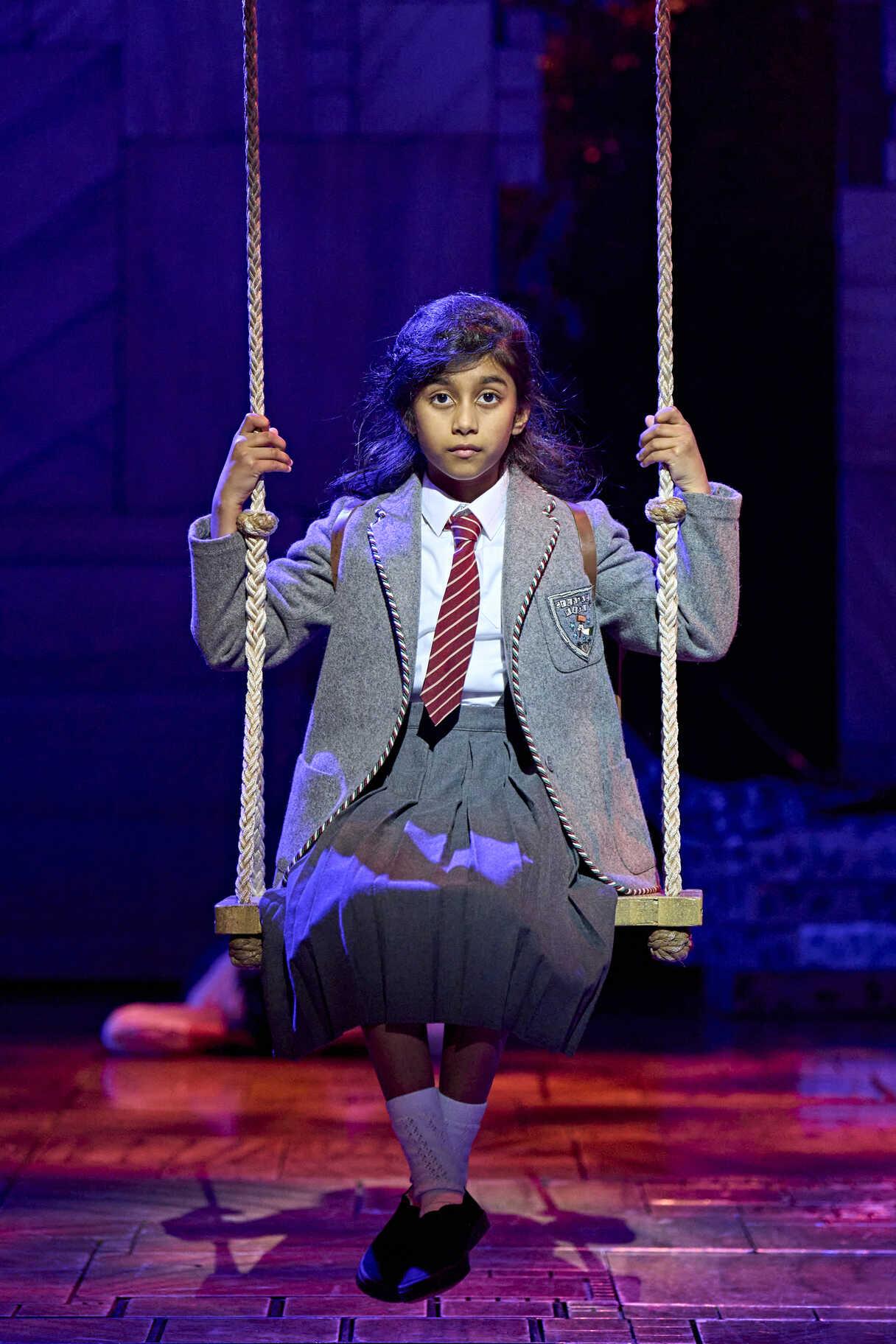 Performers in a Matilda The Musical stage scene