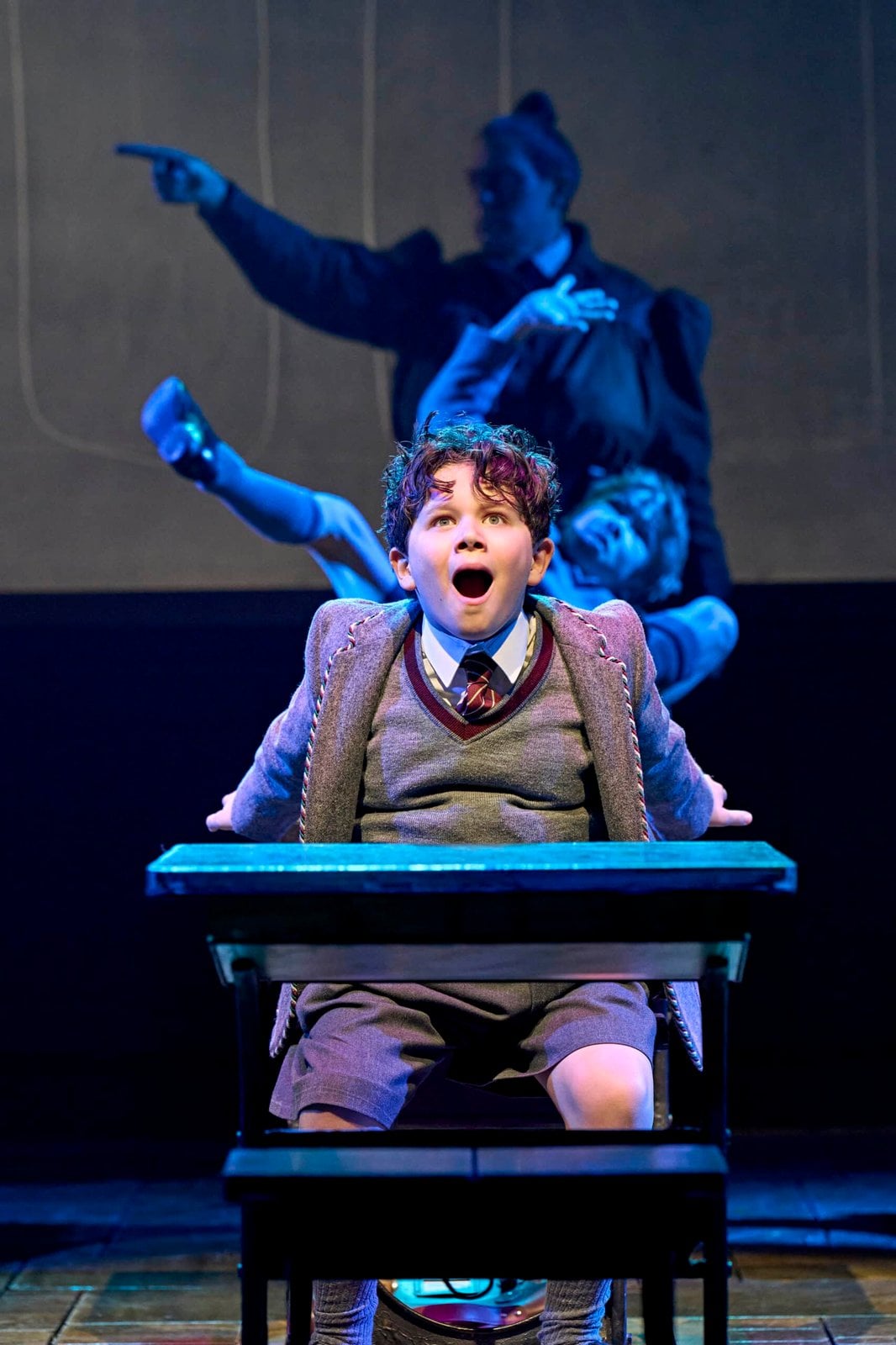A Matilda performer pictured during a stage scene