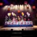 Cast performing together in a Matilda stage scene