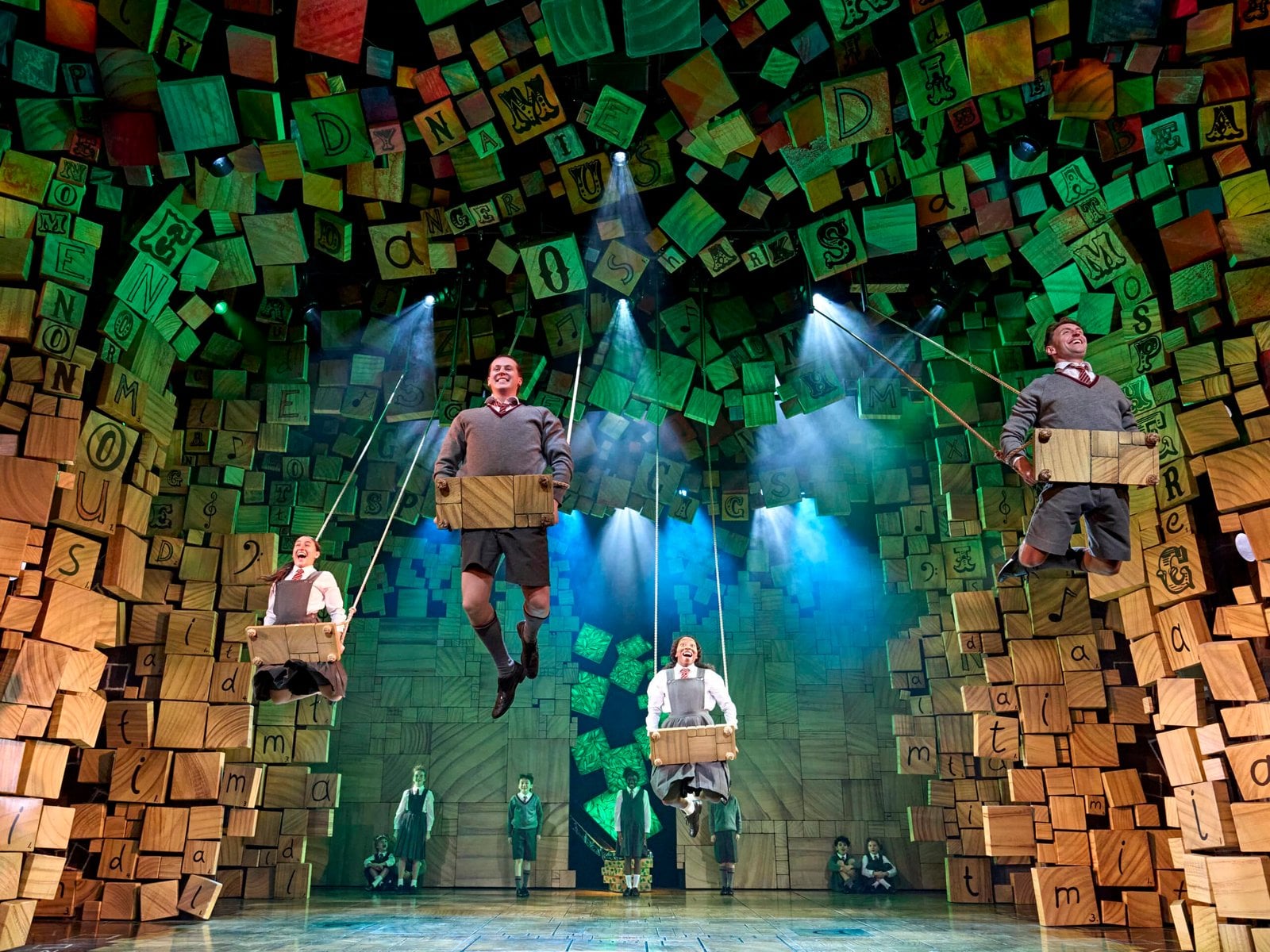 Matilda cast in a brightly lit theatre scene