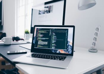 Laptop displaying code on a desk