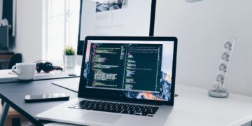 Laptop displaying code on a desk