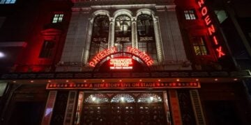 Phoenix Theatre illuminated at night with Stranger Things: The First Shadow marquee