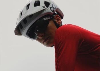 Cyclist wearing a white POC helmet and red jersey