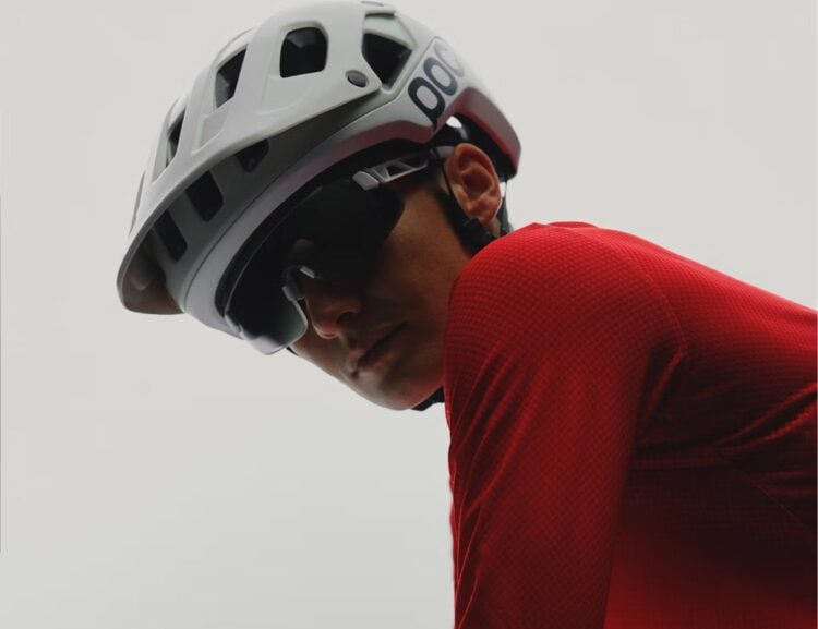 Cyclist wearing a white POC helmet and red jersey