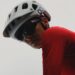 Cyclist wearing a white POC helmet and red jersey