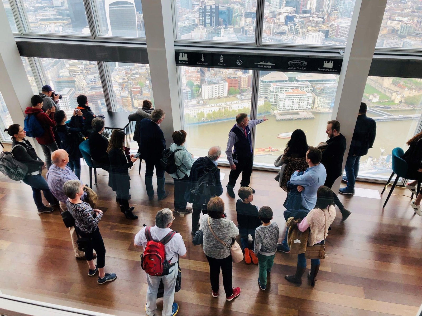 Visitors gathered around a guide in the Shard viewing gallery