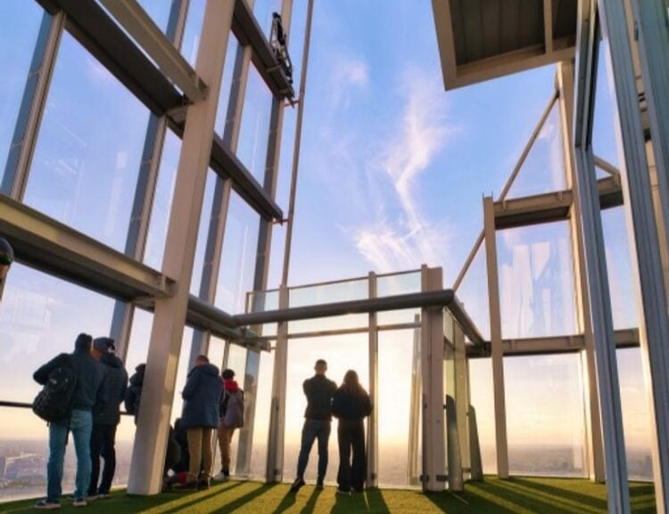 Visitors looking out from an indoor viewing level at The View from The Shard