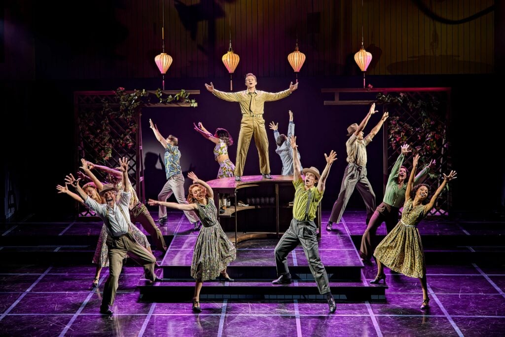Cast members performing a dramatic scene on the Sinatra the Musical stage