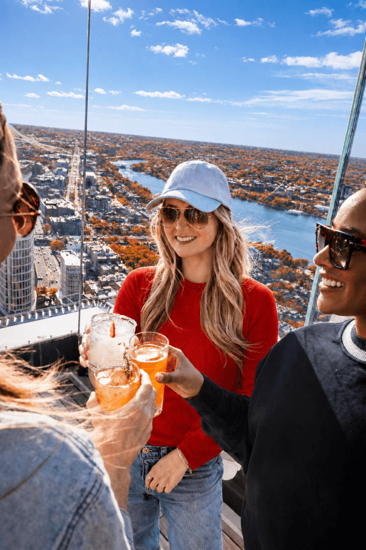 Three visitors toast at View Boston